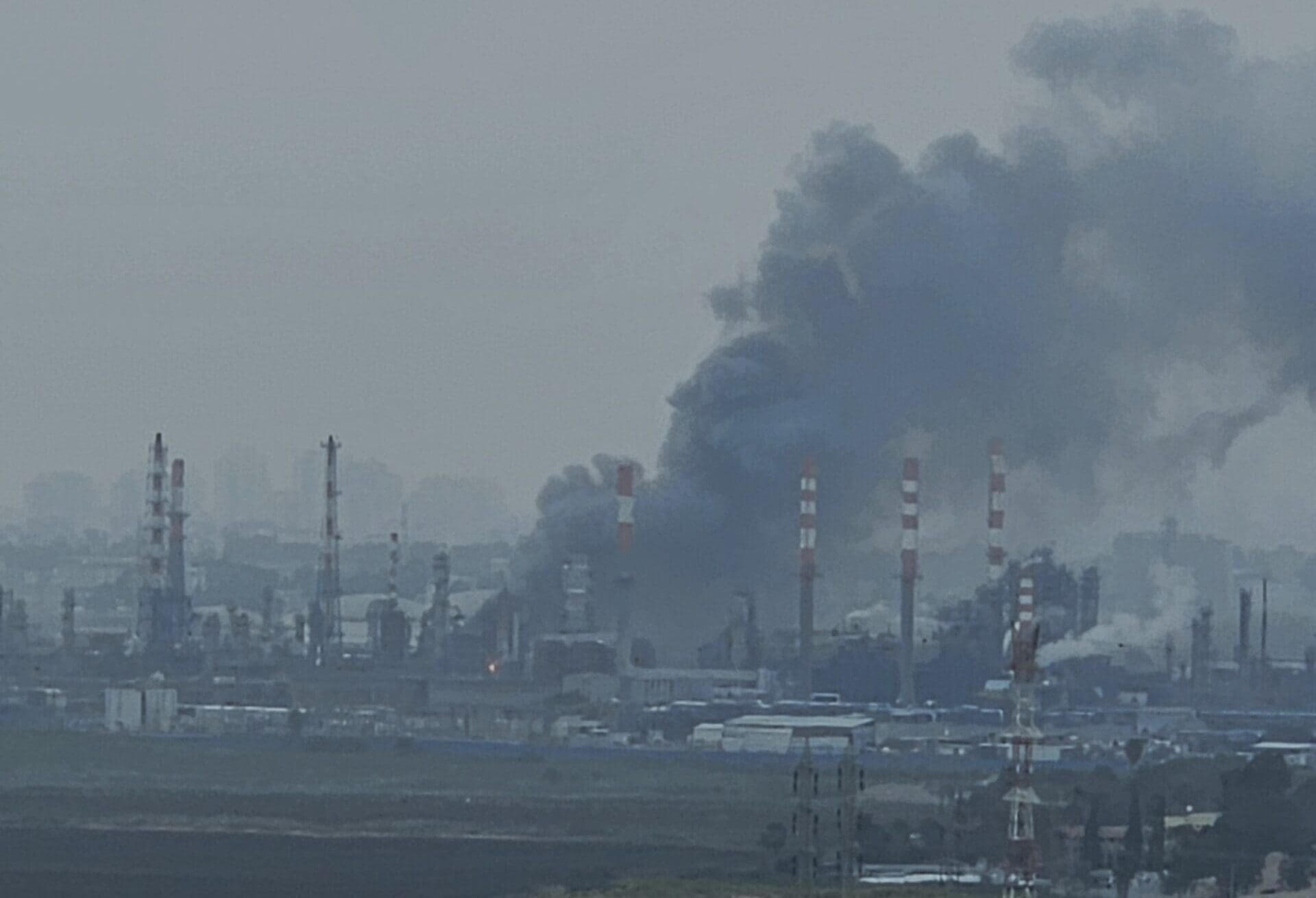 Missile interception fragments of an Iranian missile hit Haifa oil refineries in Haifa Bay, March, 19 2026. The strike caused temporary power outages after hitting a high-voltage line. Smoke was visible in the area. Photographed from the city of Nesher.