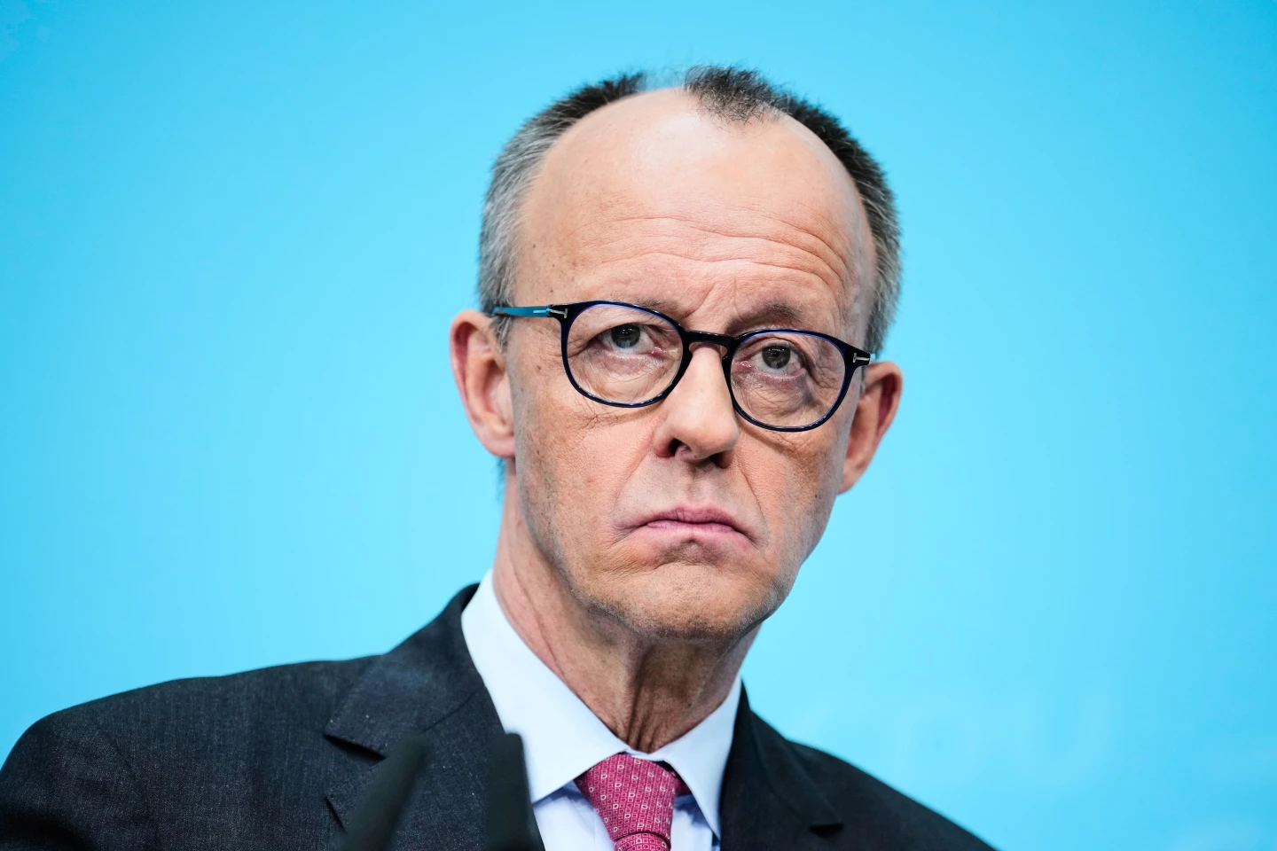 Friedrich Merz, looking concerned into a camera