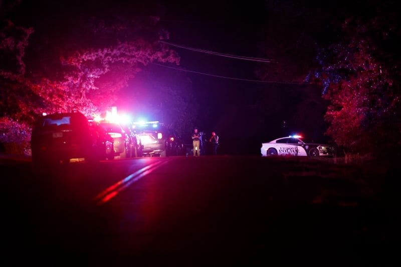 Police block off part of a street in Edmond, Oklahoma, after a campground shooting at Lake Arcadia on Sunday.