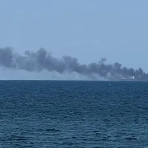 Smoke rises from a vessel on fire.