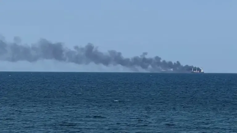 Smoke rises from a vessel on fire.