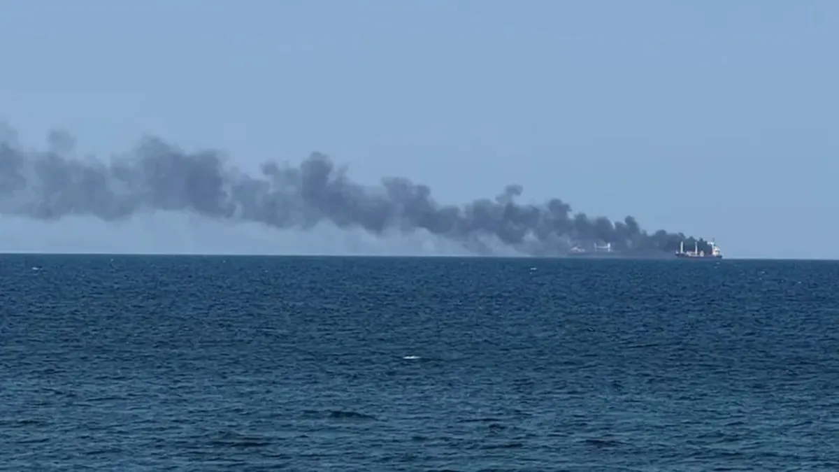 Smoke rises from a vessel on fire.